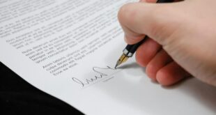 person signing in documentation paper